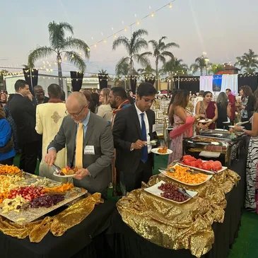 Indian food catering buffet featuring biryanis, tandoori chicken, chicken curry, vegetarian food, and vegan options prepared in a traditional clay oven.